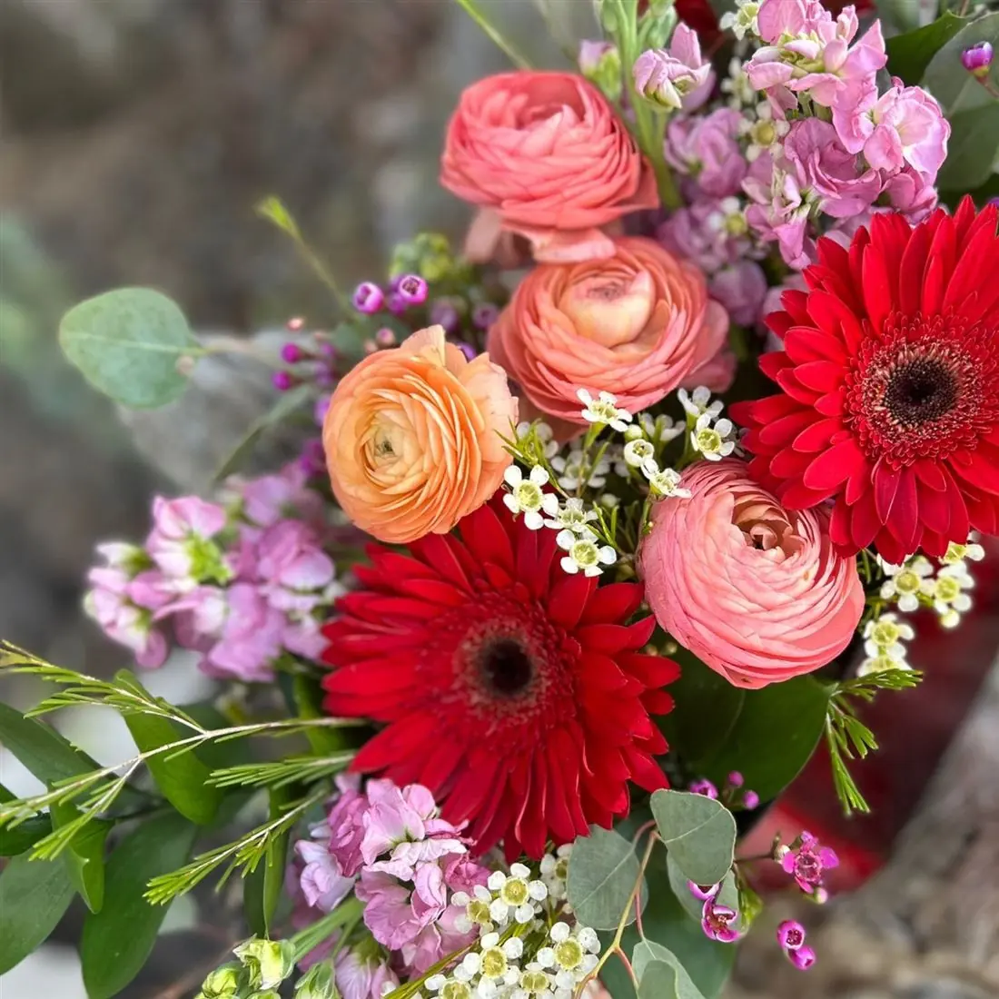 Lush red and pink seasonal arrangement by Vintage Blooms, a Kansas City florist